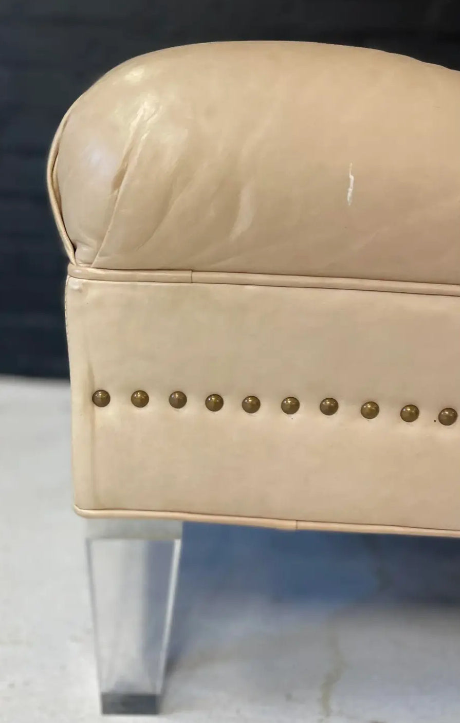 Pre-Owned Laine Cream Leather Ottoman With Brass Tack Embellishments and Lucite Legs